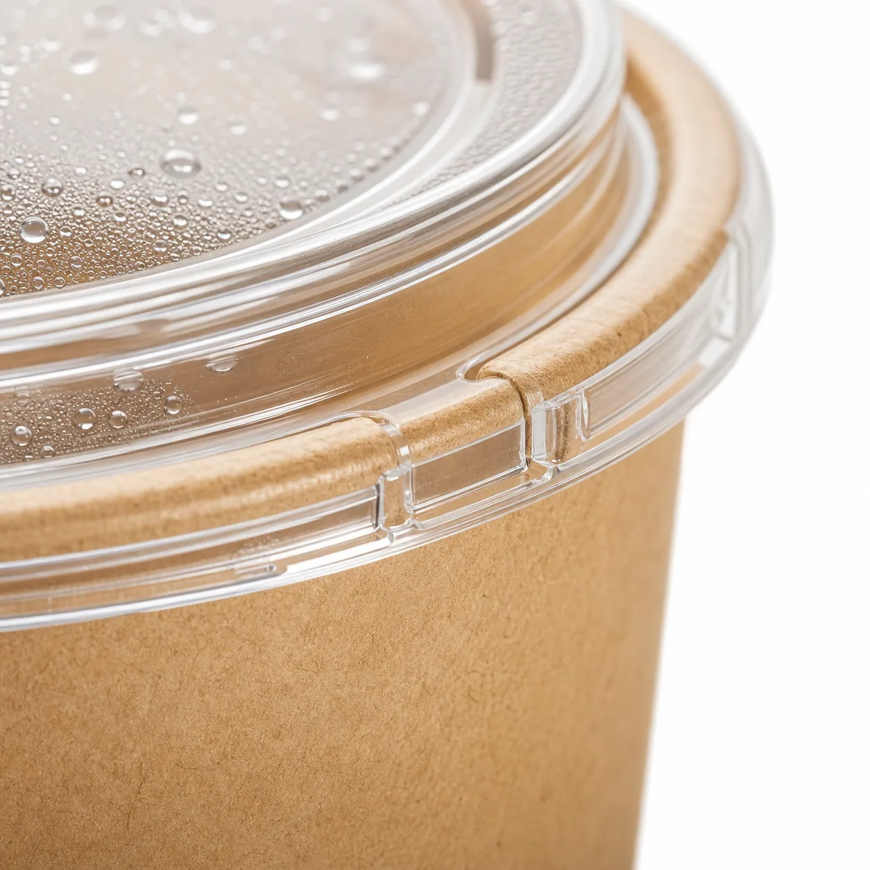 Close detail of clear lid fit on kraft paper salad bowl rim