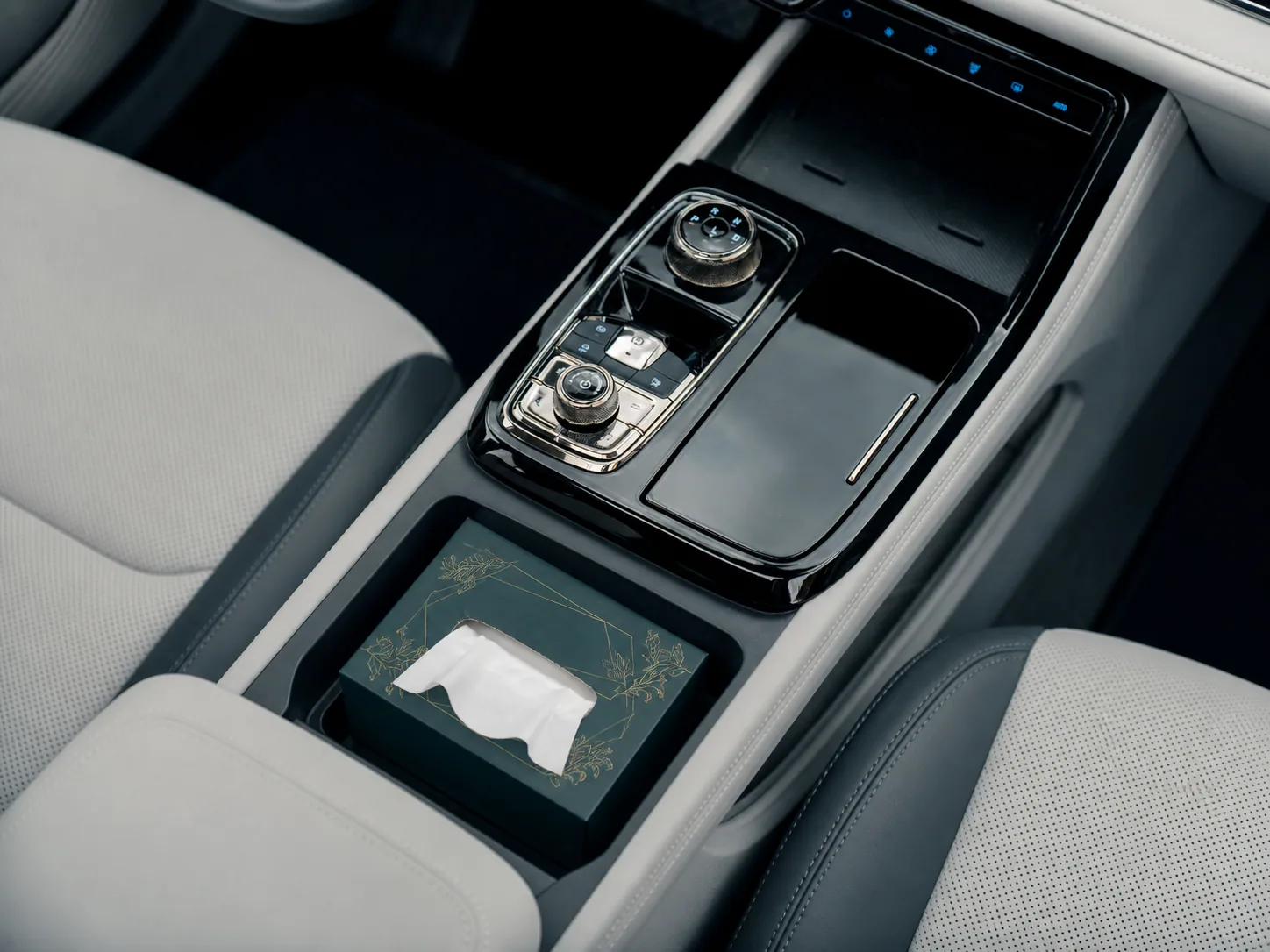 Compact facial tissue box placed in vehicle center-console storage