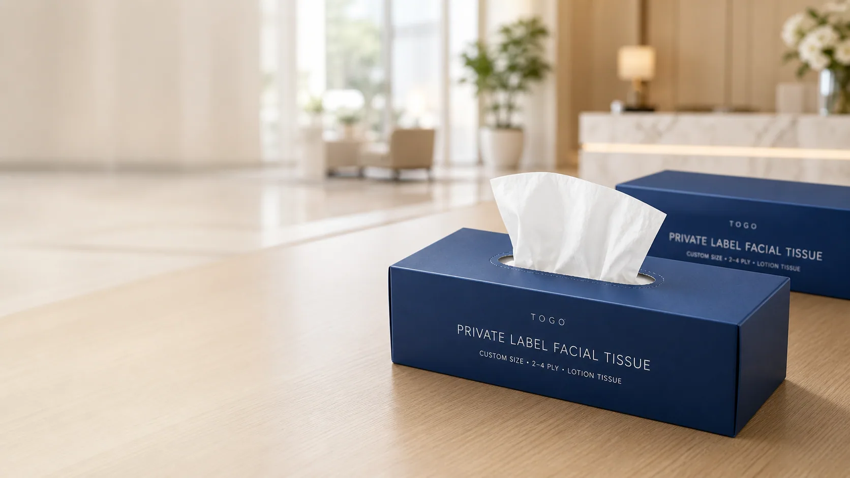 Custom printed tissue boxes with private-label facial tissue in a hotel reception setting